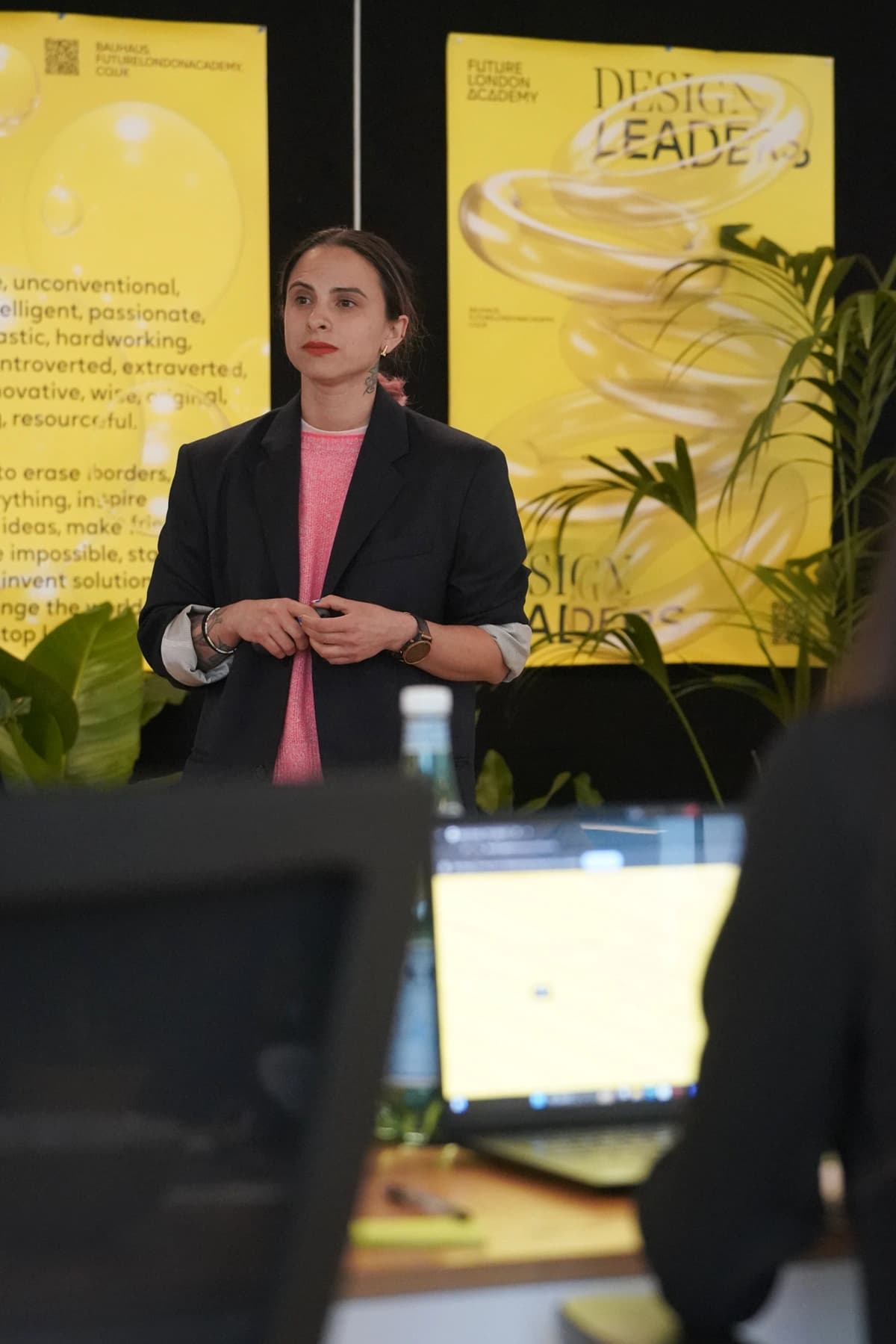 Nata presenting on stage at a design leaders event